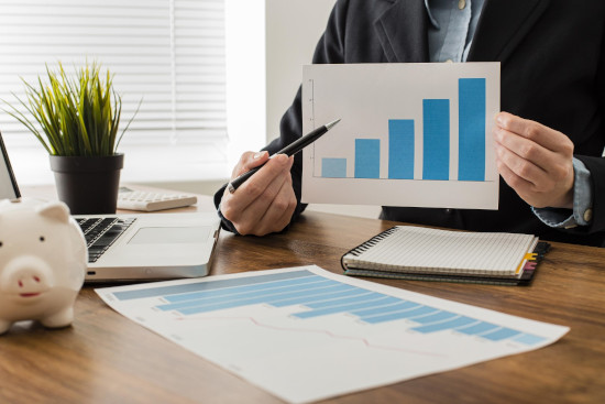 businessman-holding-growth-chart